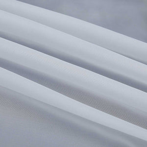Detail eines grauen, halbtransparenten Gardinenstoffs mit deutlich sichtbarem Saum und sauber gefalteten Kanten. Die feine Struktur des Stoffes lässt das Licht sanft eindringen.